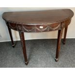 Antique demi lune table, the half-moon top above a moulded frieze, raised on square tapered legs. [