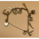 9ct yellow gold charm bracelet and various 9ct gold charms and two 18ct gold charms. 18ct gold