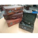 Collection of antique leather travel cases together with glass bottle display leather box .