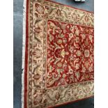 Large Indian wool rug. Ornage/ red ground. [360x275cm]