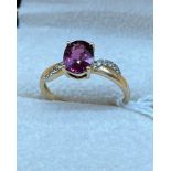 10ct yellow gold ladies ring set with a single pink tourmaline stone off set by white spinel stones.