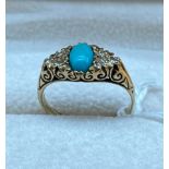 Ornate 9ct yellow gold ladies ring set with a single turquoise stone off set by three diamonds to