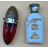 Two antique perfume bottles, One ruby glass and plated bullet shape bottle and the other is facet