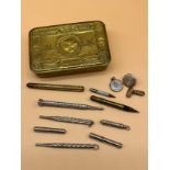 WW1 Christmas Tin containing a collection of plated revolving pencils, Includes silver pencil.