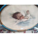 Edwardian style baby picture in decorative frame.