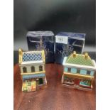 2 Royal crown Derby small shop paperweight s the Christmas shop and the green grouser with boxes .