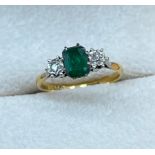 18ct gold and Platinum diamond and emerald ring. [Emerald has a chip] [Ring size P] [2.59Grams]