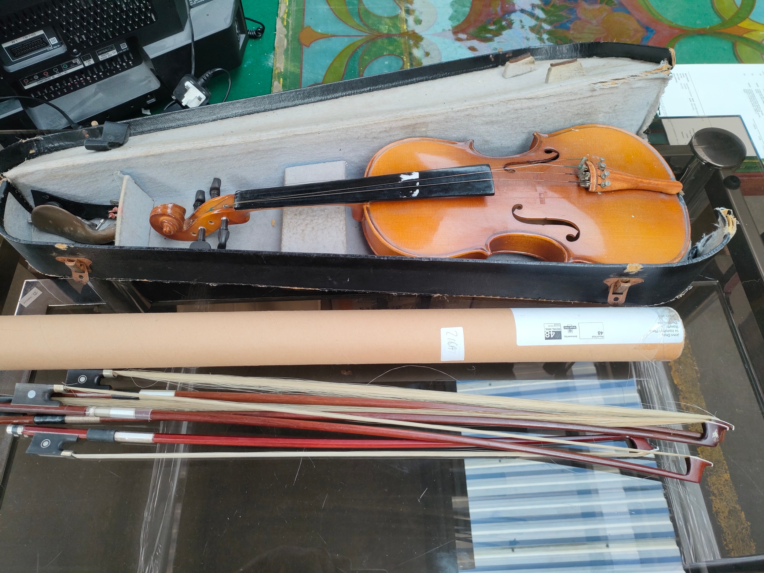 Antique violin together with 4 violin bows.