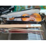 Antique violin together with 4 violin bows.