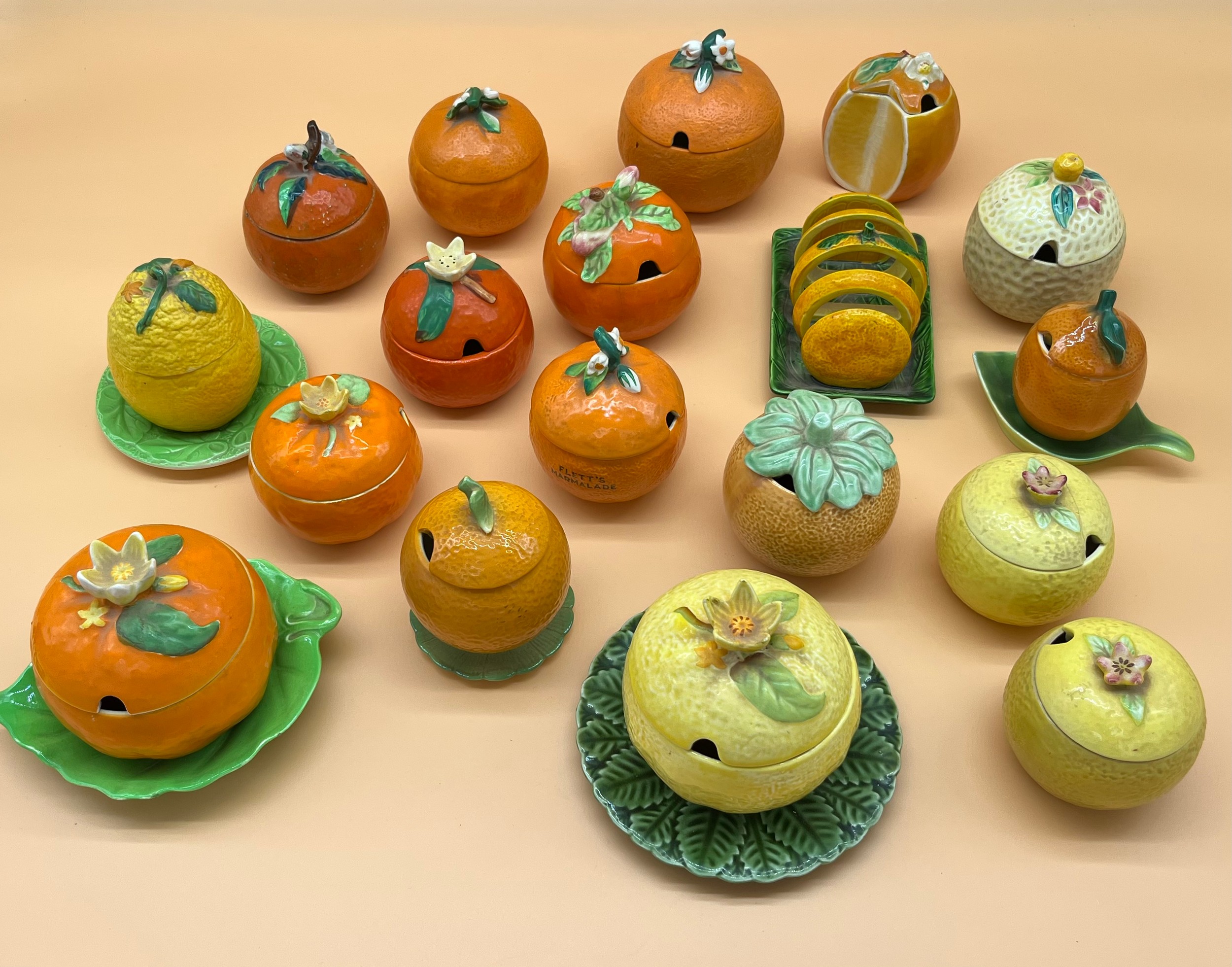 A Collection of various porcelain makers marmalade preserve pots in the form of oranges and
