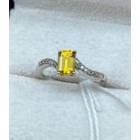 10ct white gold ladies ring set with a single emerald cut orange tourmaline stone off set by diamond