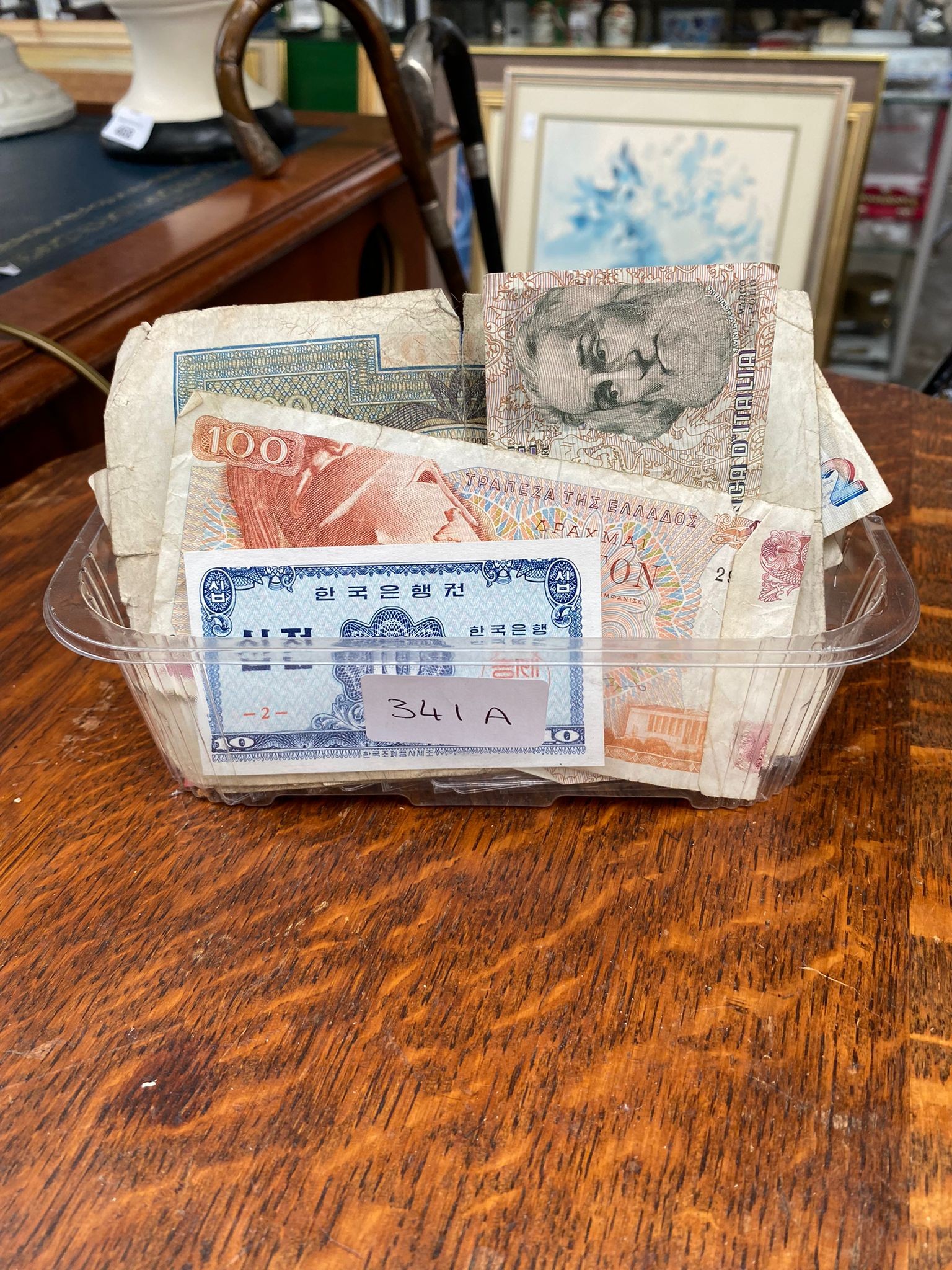 Box of various coins and notes .