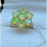 10ct yellow gold ladies ring set with 7 opalescent style stones. [Ring size P] [3.86gram]