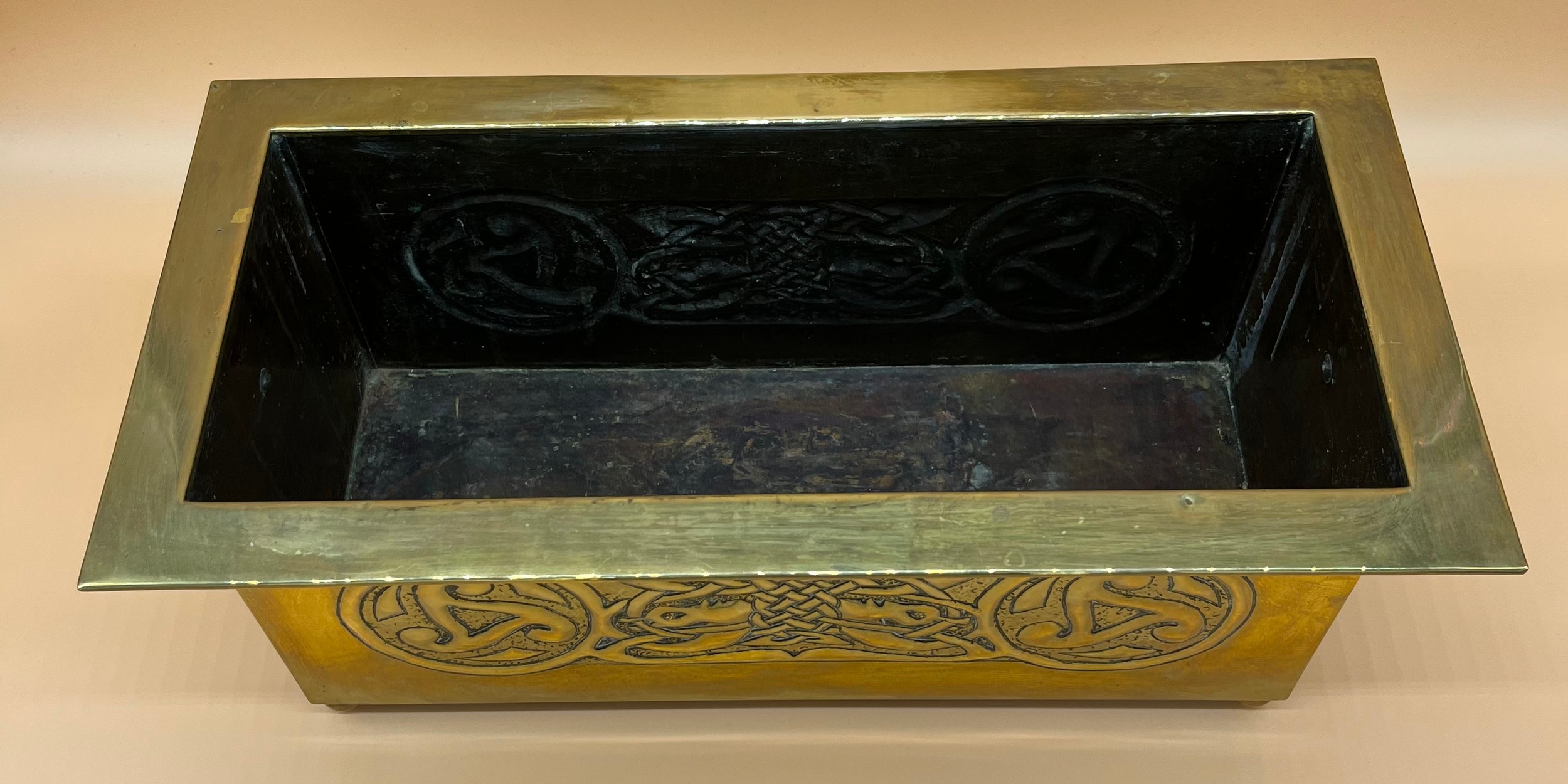 Arts and Crafts brass worked planter. detailed with Celtic panels. [Missing handle] [19x49x24cm] - Image 6 of 6