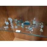 Shelf of crystal figures etc .