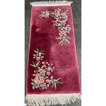 Vintage wool rug with floral design. Pink ground. Fitted with a London Lead I.D. Tag. [150x70cm]