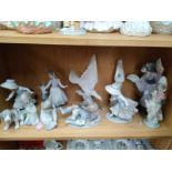 Shelf of various Lladro and Nao figurines (all in need of attention)