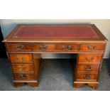 A Reproduction red leather top knee hole writing desk. Splits into three pieces for