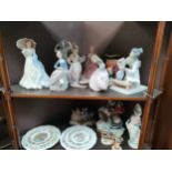 2 shelf's of collectables to include lladro , nao etc mostly as found .