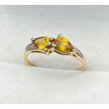 10ct yellow gold ring set with two tear drop cut yellow tourmalines off set by diamonds to each