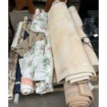 Pallet of upholstery material and rugs.