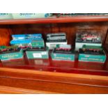 Shelf of boxed Eddie stobart model trucks etc