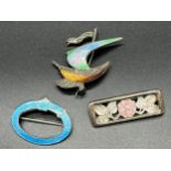 Three various silver and enamel brooches. Birmingham silver and blue enamel buckle style brooch,