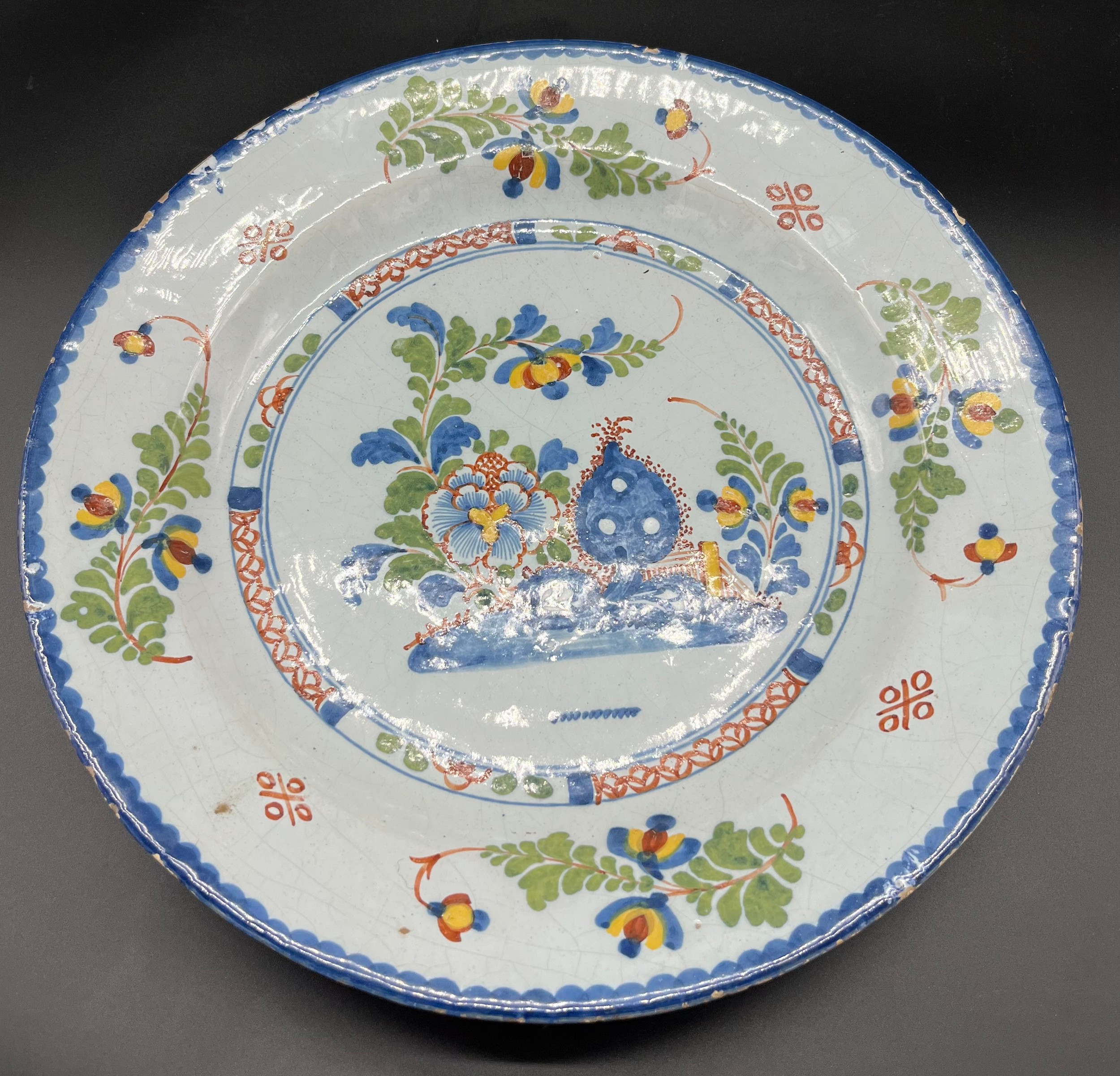 18th century delft hand painted wall charger bowl/ plate. Decorated with foliage/ flowers and ornate