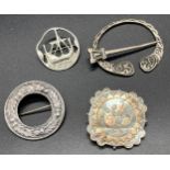 Four various silver brooches. Includes Celtic plaid brooch, Edinburgh silver long boat brooch by