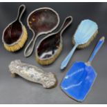 Three-piece silver and tortoise shell dressing table brushes and hand mirror, Two silver and blue