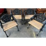 Lot of four black cast iron seats, the shaped back with dog and foliate design above a