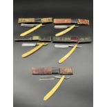 Five vintage cut throat razors with boxes. Includes ERN, MoDoSo and Glasgow maker. background to