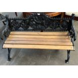 Black cast iron bench, the shaped back with dog and foliate design above a wooden slat