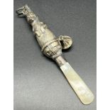 Birmingham silver and mother of pearl handle baby rattle. Silver is formed in the shape of a