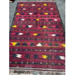 Large hand woven Turkish Kilim rug. Red ground. [300x190cm] [Signs of wear]