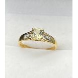 10ct yellow gold ladies ring set with a single cushion cut pale green spinel ring off set by diamond