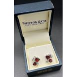 A Pair of ladies Shipton & co 925 silver earrings set with garnet stones.
