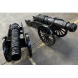 Lot of two heavy black painted cast iron canons. [47x95x35cm