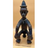 Antique African Nigerian hand carved wooden tribal seated figure, decorated with cone shaped hat,