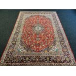 Large Persian carpet/rug, highly decorative with red ground. [535x296cm]
