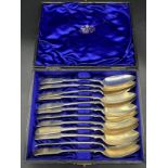 A Boxed set of 12 Glasgow silver dessert spoons. All number 1-12and Engraved with initials. Produced
