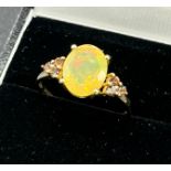 10ct yellow gold ladies ring set with a large opalescent style stone off set by smokey quartz