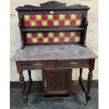 Antique washstand, the art nouveau themed tile back with open shelf above a marble surface, two