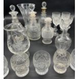 A Collection of crystal decanters and glasses includes silver top decanter, Edinburgh crystal wine