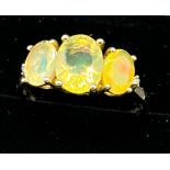 10ct yellow gold ladies ring set with three opalescent style stones. [Ring size R] [2.66Grams]