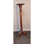 19th century torcher stand, with carved foliate design to the column, raised on a tripod base [112cm