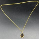 9ct yellow gold necklace together with a 9ct gold and smokey quartz pendant. [24cm in length