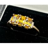 10ct yellow gold ladies ring set with three emerald cut yellow tourmaline stones off set by