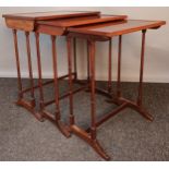 Antique nest of three tables, the surface with parquetry inlay and raised on trestle supports[