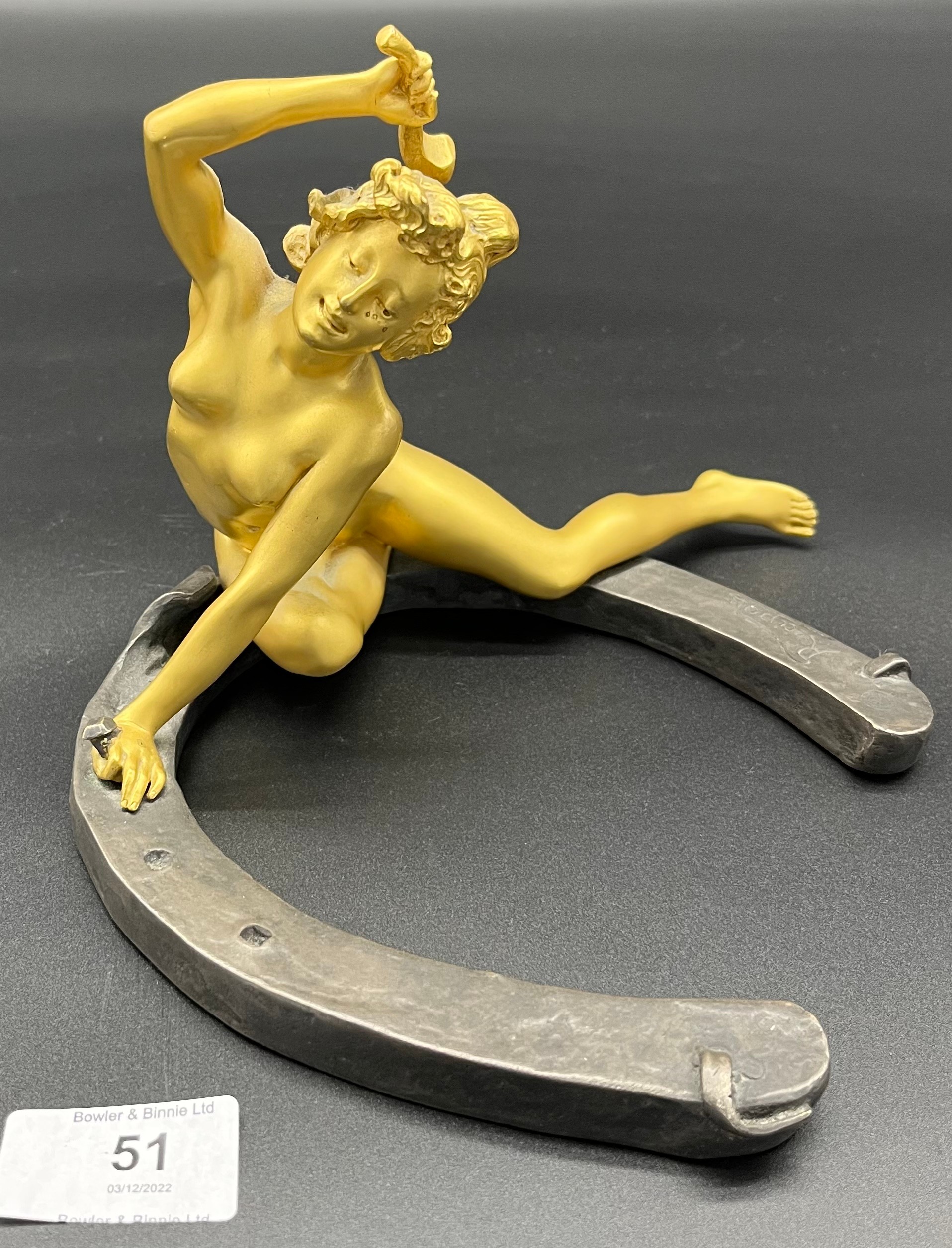 Art Nouveau Nude lady gilt bronze on horseshoe hammering a nail, signed Recipon. The bronze is